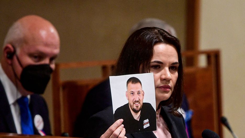 Temporary(FILES) In this file photo taken on June 09, 2021 Belarusian opposition leader Svetlana Tikhanovskaya (R) holds a picture of her husband, the opposition figure jailed blogger Sergei Tikhanovsky, during her speech at the Senate of the Parliament of the Czech Republic in Prague, Czech Republic. - A court in Belarus on December 14, 2021 sentenced opposition leader Sergei Tikhanovsky to 18 years in prison after he galvanised an unprecedented protest movement against strongman leader Alexander Lukashenko last year, state media said. (Photo by ROMAN VONDROUS / various sources / AFP)ROMAN VONDROUS
