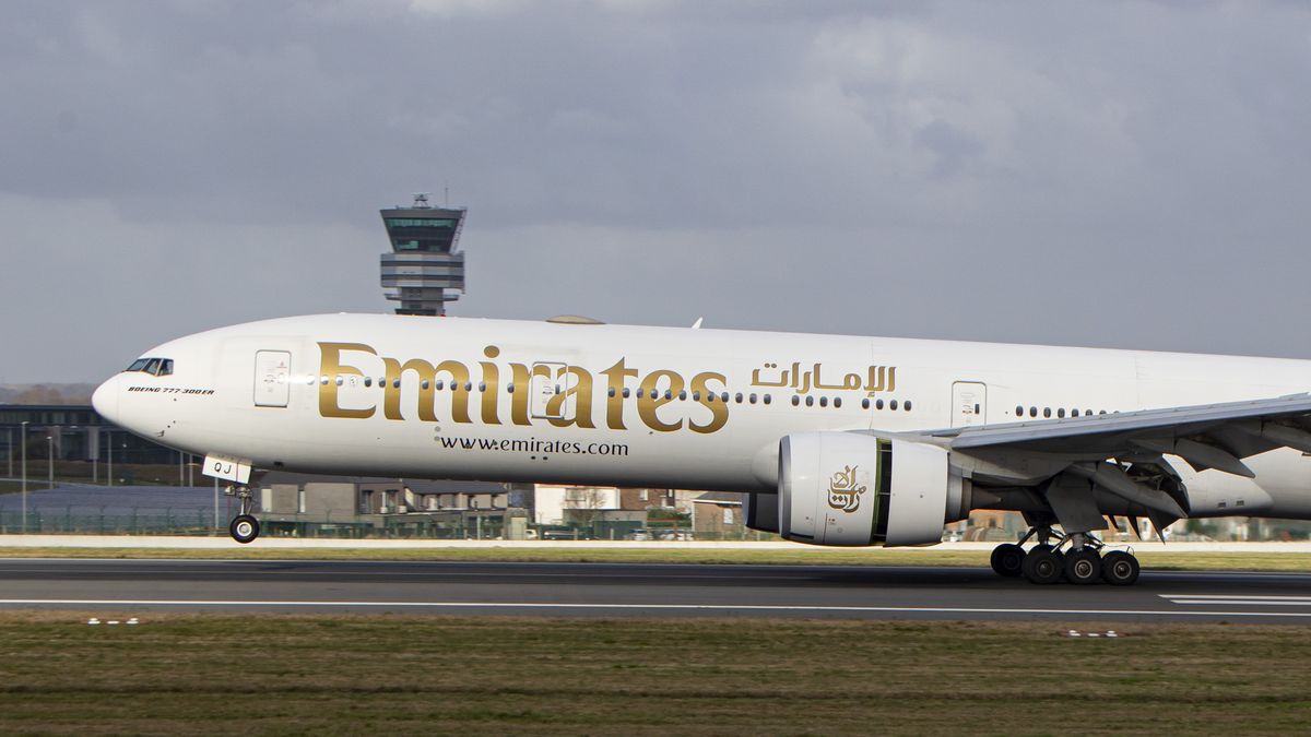 Emirates Boeing 777 aircraft as seen flying and landing on the runway with the control tower and the clouds in the background. Emirates B777 airplane as seen on final approach flying, landing and taxiing at the Belgian capital, Brussels Airport Zaventem BRU. The Boeing Boeing 777-31HER modern and advanced wide-body passenger airplane has the registration A6-EQJ and is powered by 2x GE90 jet engines. The plane is arriving at the European city from Dubai DXB, UAE. Emirates is largest airline and one of the two, flag carrier of the United Arab Emirates. The aviation industry and passenger traffic are phasing a difficult period with the Covid-19 coronavirus pandemic having a negative impact on the travel business industry with fears of a deteriorating situation due to the Delta and Omicron variant mutation at the fifth wave. Brussels, Belgium on January 30, 2022 (Photo by Nicolas Economou/NurPhoto via Getty Images)
