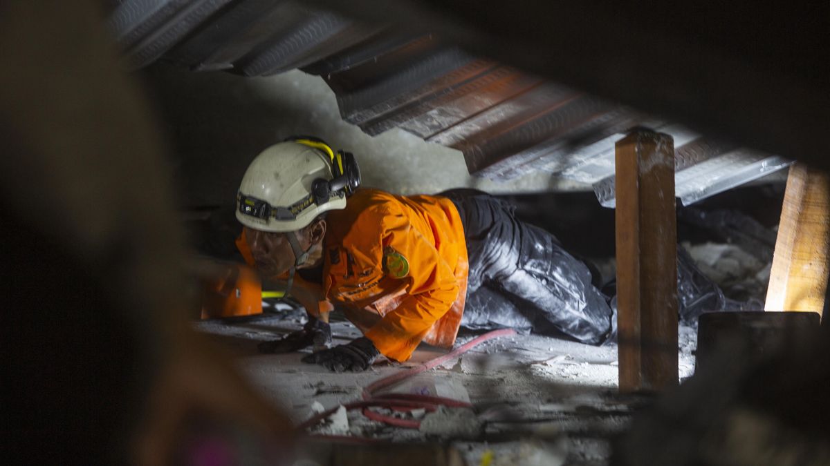 Poszukiwania osób uwięzionych w zawalonym budynku w Indonezji