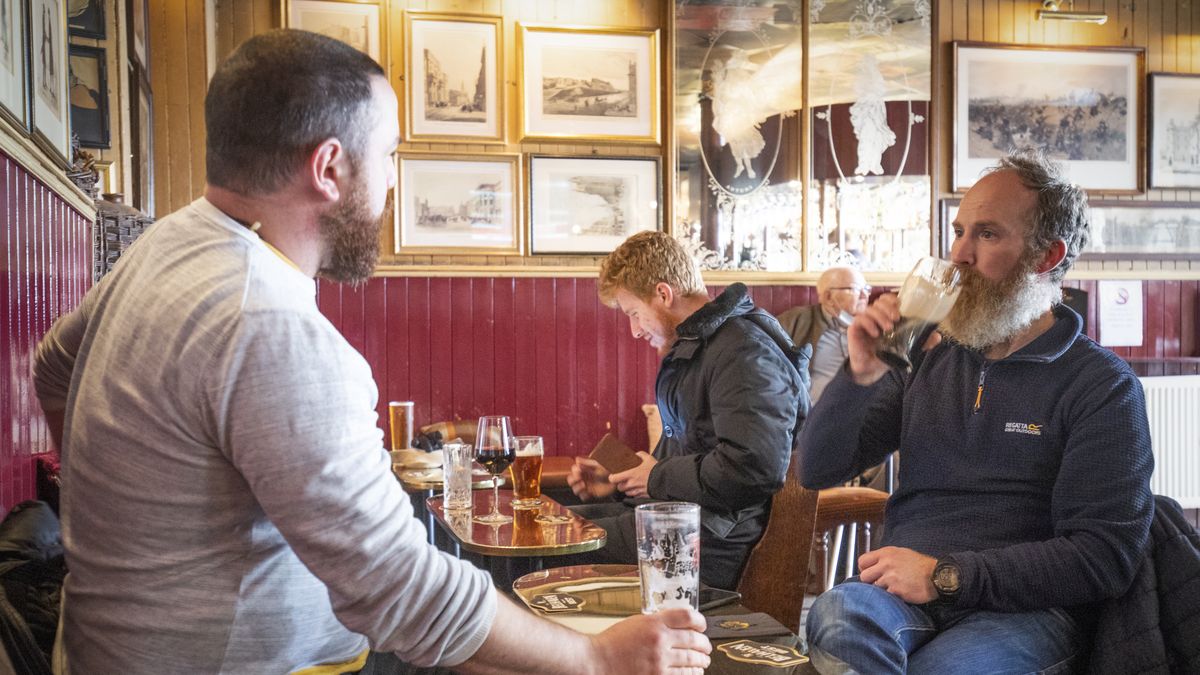 Customers in the Waverley, Edinburgh, enjoy a drink inside the bar. Alcohol can now be served inside pubs and restaurants, which are allowed to stay open until 22.30, as Scotland moves to Level 2 restrictions to ease out of lockdown. (Photo by Jane Barlow/PA Images via Getty Images)