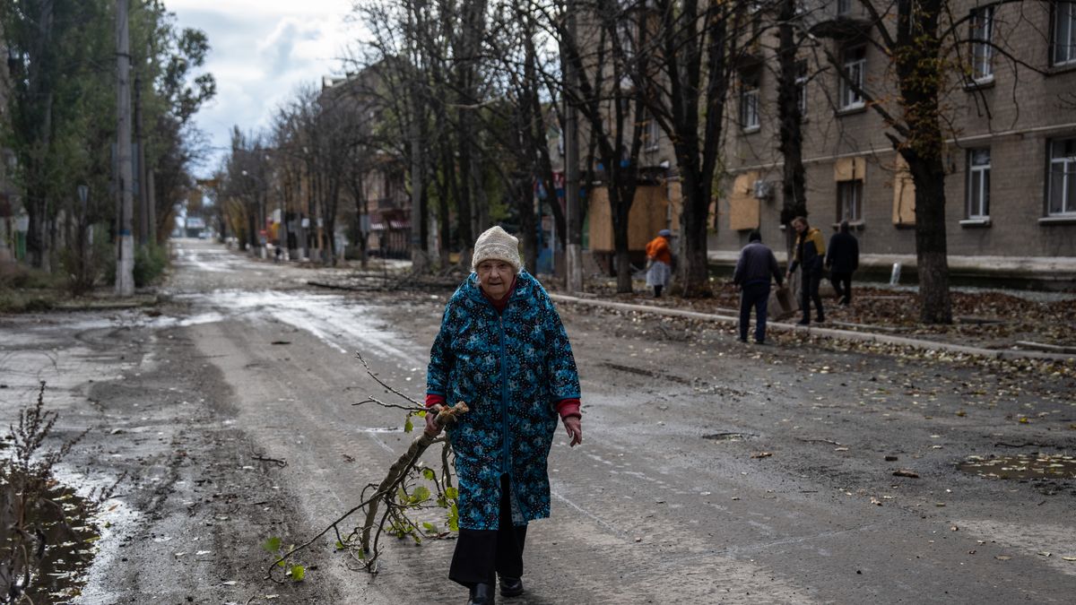 BAKHMUT, UKRAINE - OCTOBER 21: An elderly lady collects fallen tree branches to use as firewood on October 21, 2022 in Bakhmut, Donetsk oblast, Ukraine. Ukrainian president Volodymyr Zelensky has accused Russia of preparing to blow up the Kakhovka dam on the Dnieper River which could lead to a "large-scale disaster" including the flooding of around 80 settlements and the regional capital Kherson. (Photo by Carl Court/Getty Images)