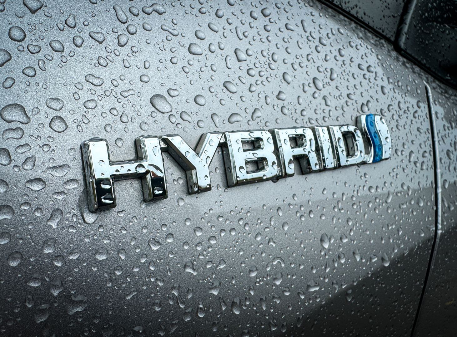 MORZINE, FRANCE - APRIL 04: Rain drops gather on the hybrid badge on a car in the village of St Jean d'Aulps on April 4, 2024 near Morzine, France. The European Union plans to ban all new sales of carbon-emitting petrol and diesel cars by 2035. Originally the UK planned to ban the sale of new petrol and diesel cars in Britain will by 2030, however this has recently put back still further. Critics of the laws have expressed concern that many internal combustion engined carbon polluting cars, lorries and vans will be still on the roads long after the ban on their sale. (Photo by Matt Cardy/Getty Images)