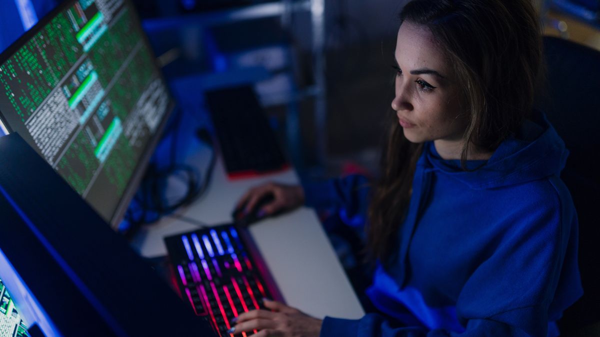 Young woman hacker by computer in the dark room at night, cyberwar concept.A young woman hacker by computer in the dark room at night, cyberwar concept.cyber, attack, hacker, code, network, coding, data, web, internet, crime, criminal, screen, virus, dangerous, computer, information, security, laptop, system, monitor, typing, hacking, technology, binary, digital, privacy, software, government, keyboard, hack, programming, night, server, spy, thief, dark, blue, concept, firewall, display, program, basement, person, malware, woman, interface, fraud, developer, young, metaverse, cyber, attack, hacker, code, network, coding, data, web, internet, crime, criminal, screen, virus, dangerous, computer, information, security, laptop, system, monitor, typing, hacking, technology, binary, digital, privacy, software, government, keyboard, hack, programming, night, server, spy, thief, dark, blue, concept, firewall, display, program, basement, person, malware, woman, interface, fraud, developer, young, metaverse