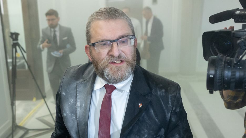 Grzegorz Braun, a far-right Polish lawmaker, is using a fire extinguisher on Hanukkah candles in parliament in Warsaw, Poland, on December 12, 2023. (Photo by Foto Olimpik/NurPhoto via Getty Images)