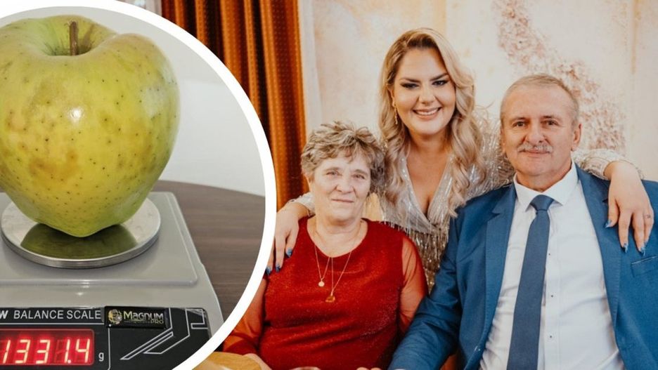 Mieczysław Socha z rodziną i jego wyjątkowo dorodne jabłko.