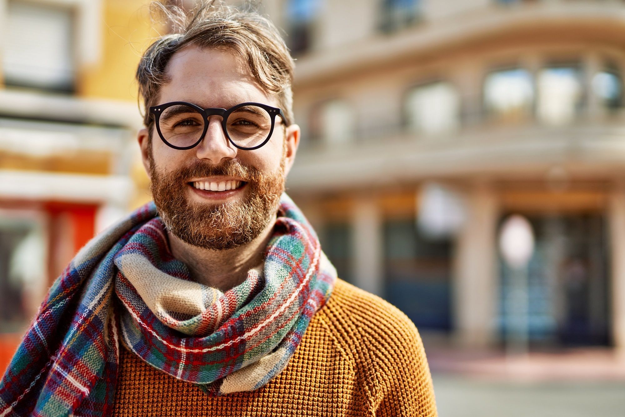 Young caucasian man with beard wearing glasses outdoors on a sunny dayYoung caucasian man with beard wearing glasses outdoors on a sunny dayadult, attractive, beard, blond, casual, caucasian, cheerful, city, clothing, confident, face, fashion, glasses, guy, handsome, happy, healthy, intelligent, irish, lifestyle, male, man, mature, modern, one, outdoor, outdoors, people, person, portrait, positive, red head, redhead, scarf, smart, smile, smiling, street, sweater, town, trendy, urban, wearing, young