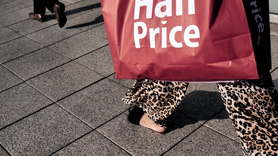 A shopper carries a HalfPrice.eu branded bag in Warsaw, Poland on Tuesday, Aug. 16, 2022. Polands economy shrank more than expected in the second quarter, making a technical recession more likely according to analysts at mBank SA. Photographer: Bartek Sadowski/Bloomberg via Getty Images