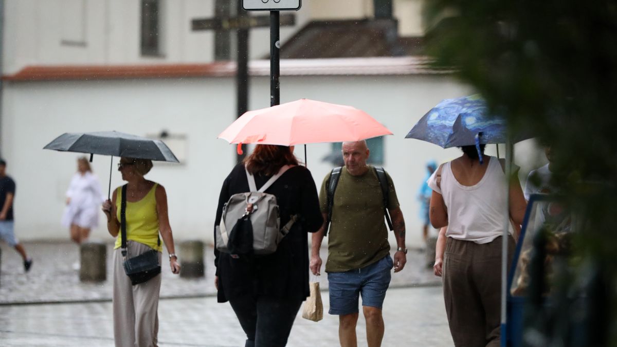 People with umbrellas walk in the rain on the street in Krakow, Poland, on August 21, 2024. (Photo by Klaudia Radecka/NurPhoto via Getty Images)