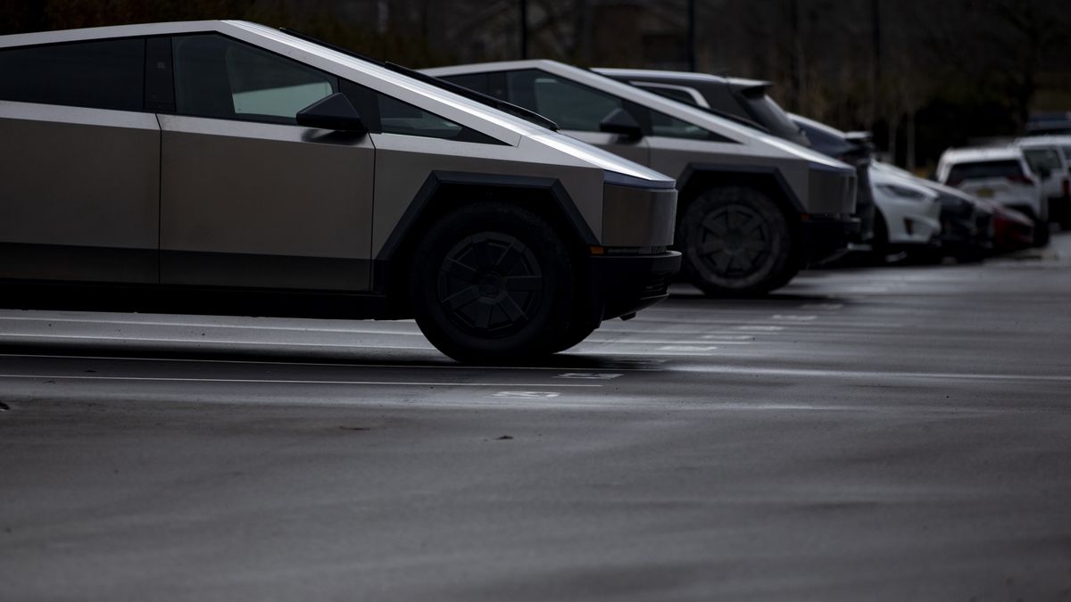 A Tesla Cybertruck and other vehicles in the parking lot of a Tesla showroom in West Bloomfield, Michigan, US, on Thursday, March 20, 2025. The electric-vehicle maker has been hit by headline-grabbing protests and vandalism in recent weeks, part of a backlash to Chief Executive Officer Elon Musks role in the Trump administrations efforts to slash the federal government. Photographer: Emily Elconin/Bloomberg via Getty Images