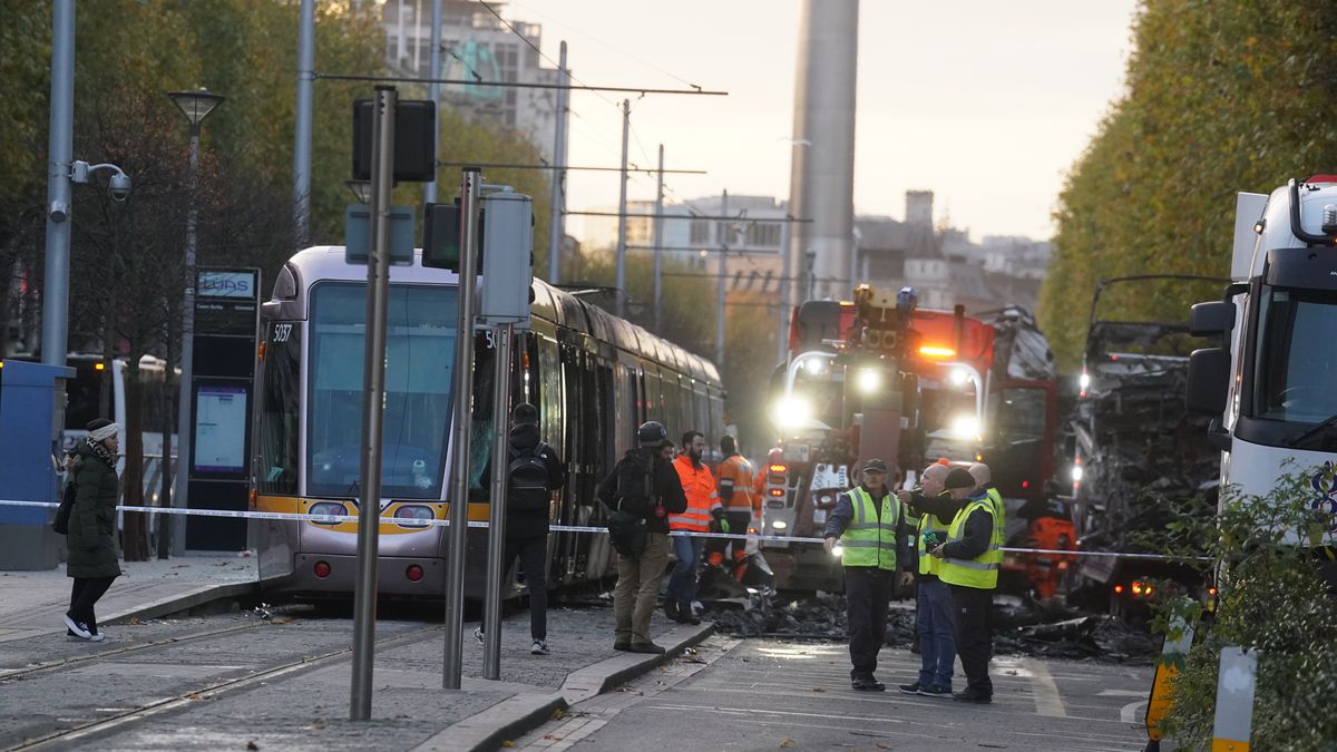 Debris is cleared from a burned out Luas and bus on O'Connell Street in Dublin, in the aftermath of violent scenes in the city centre on Thursday evening. The unrest came after an attack on Parnell Square East where five people were injured, including three young children. Picture date: Friday November 24, 2023. (Photo by Brian Lawless/PA Images via Getty Images)