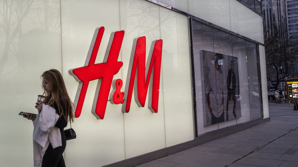 BEIJING, CHINA - MARCH 25: A woman walks by the flagship store of clothing brand H&M at a shopping area on March 25, 2021 in Beijing, China. Chinese state media and social networking platforms called for boycotts of major Western brands, including H&M, after statements made by the companies in the past about Xinjiang cotton resurfaced online. (Photo by Kevin Frayer/Getty Images)