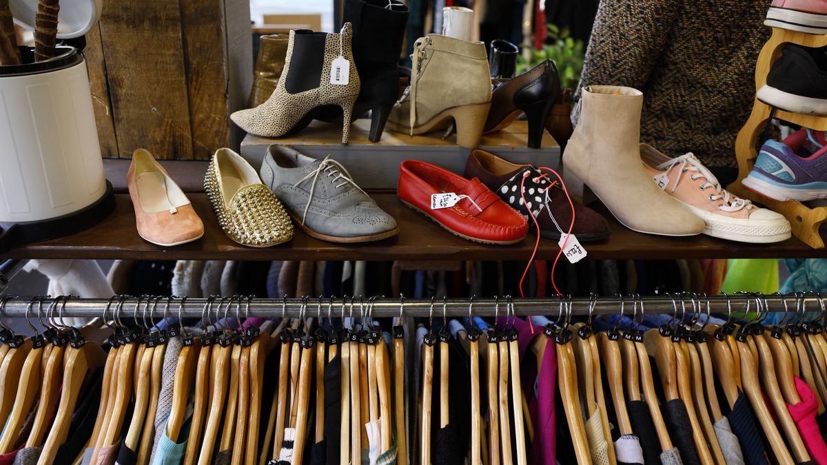Shoes and clothing on display in a second hand vintage storeThe interior of a second hand vintage charity clothing shop - sustainable fashionNick David