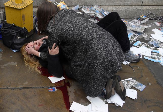 Zdjęcie powstało po tym jak Khalid Masood wjechał w ludzi na Westminster Bridge. Przechodzień pociesza kobietę, ucierpiałą w wypadku. Zabił 5 osób, wiele innych zostało rannych.