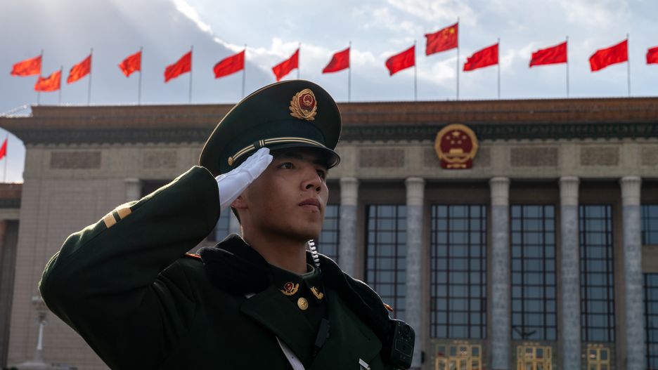 A member of the People's Liberation Army salutes outside the Great Hall of the People following the closing of the Second Session of the 14th National People's Congress (NPC) in Beijing, China, on Monday, March 11, 2024. The Chinese legislature voted to change a four-decade-old law so it tightens the Communist Party's grip on the cabinet, underscoring President Xi Jinping's drive to give the party control over all the main levers of government. Source: Bloomberg