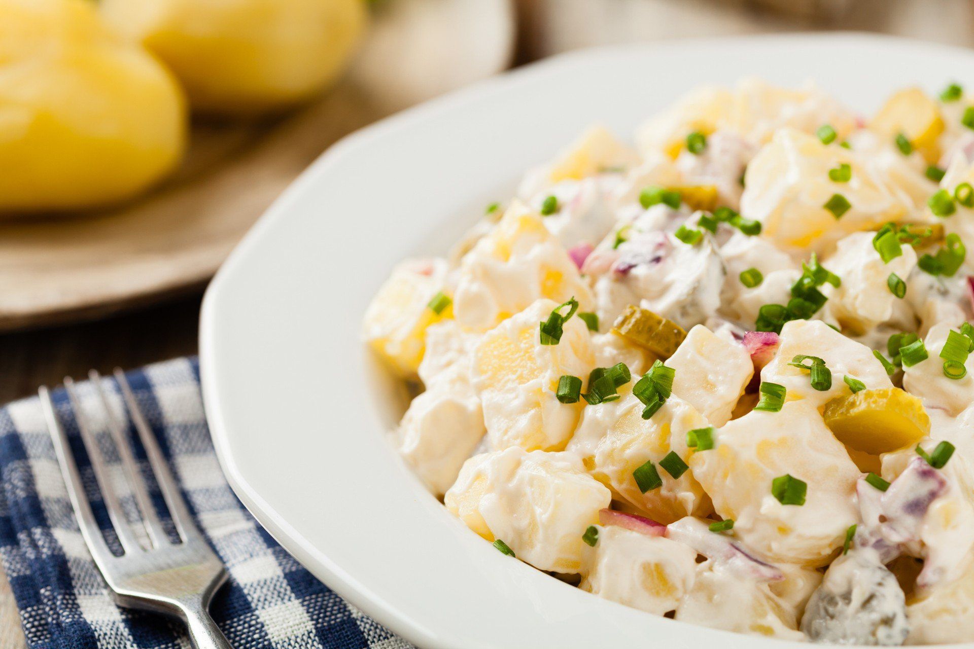 Traditional German potato salad with cucumber, onion and mayonnaise.