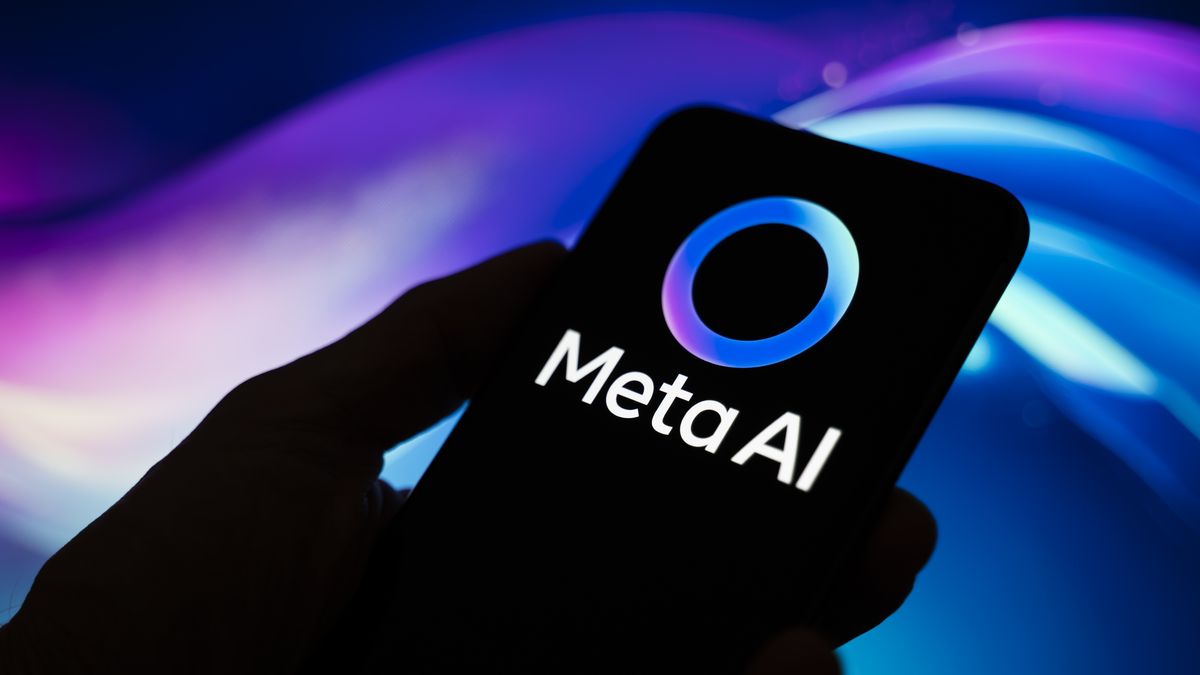 In Créteil, France, on September 29, 2025, the Meta AI logo appears on a smartphone held in one hand with an abstract illustration of blue and purple colors in the background. Meta, the parent company of WhatsApp and Meta AI, makes the Artificial Intelligence assistant mandatory in its instant messaging app. (Photo Illustration by Samuel Boivin/NurPhoto via Getty Images)