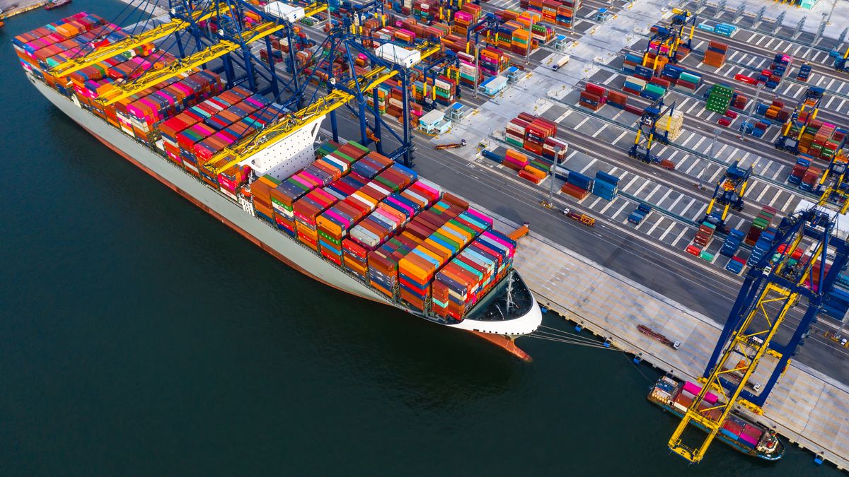 Container ship freight shipping containers box at the docks, Aerial view stack of containers in a container ship at deep sea port.Container ship freight shipping containers box at the docks, Aerial view stack of containers in a container ship at deep sea port.AvigatorPhotographer