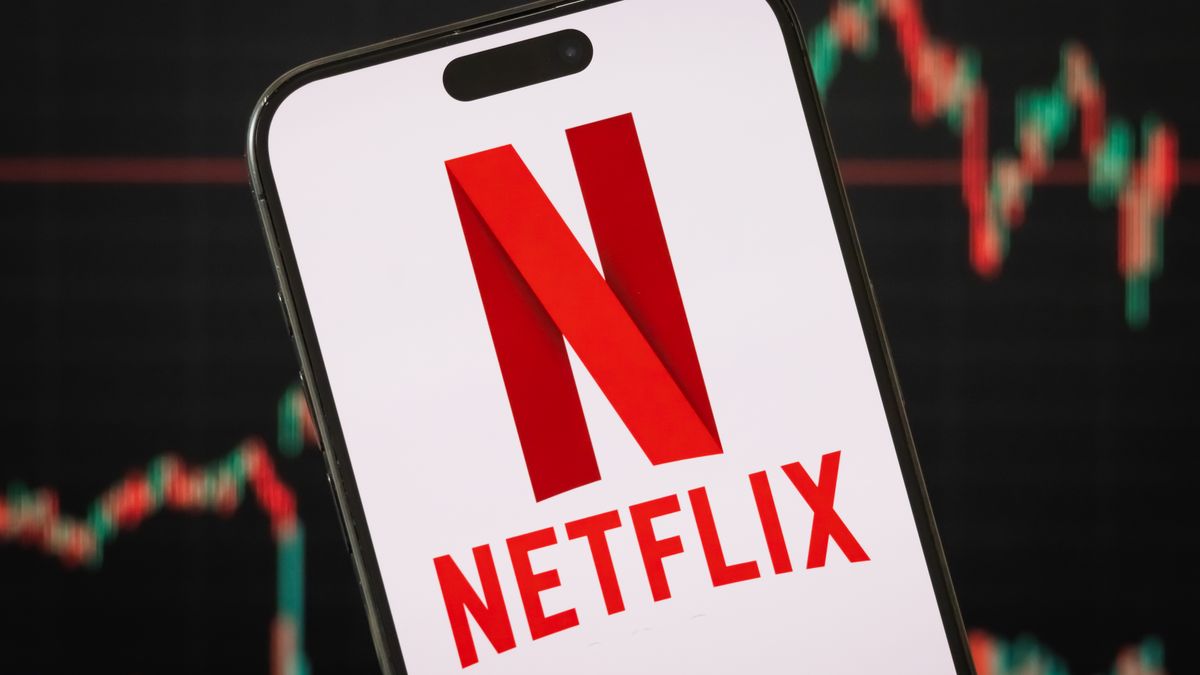 CHONGQING, CHINA - APRIL 14: In this photo illustration, the Netflix logo is displayed on a smartphone screen, with the company's latest stock price performance and candlestick chart visible in the background, reflecting market volatility and investor sentiment on April 14, 2025, in Chongqing, China. Netflix, Inc. is a global streaming entertainment service provider offering subscription-based video content, including original TV series, movies, documentaries, and licensed content. (Photo by Cheng Xin/Getty Images)
