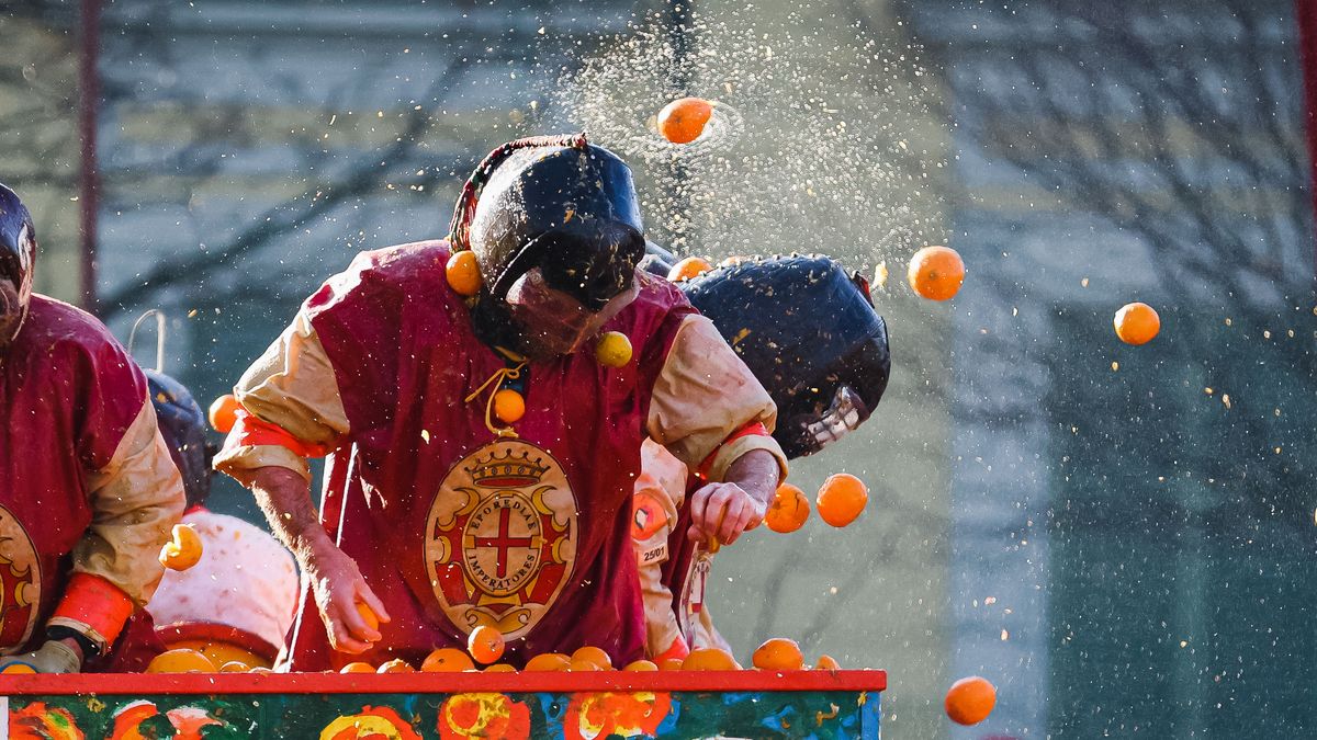 People are attending the Battle of the Oranges during The Historical Carnival of Ivrea in Ivrea, Italy, on February 19, 2023. (Photo by Alessandro Bremec/NurPhoto via Getty Images)