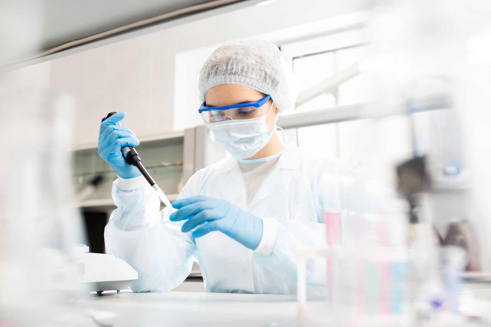 Microbiologist at work
Serious concentrated female microbiologist in sterile clothing and safety goggles sitting at table and dropping reagent in petri dish while doing research in laboratory
people, woman, young, adult, science, experiment, clinic, laboratory, research, medical, chemistry, biology, pharmacy, pharmaceutical, looking, biohazard, glove, protective, cap, mask, concentrated, goggles, dropping, petri dish, microbiology, biotechnology, researcher, working, sterile