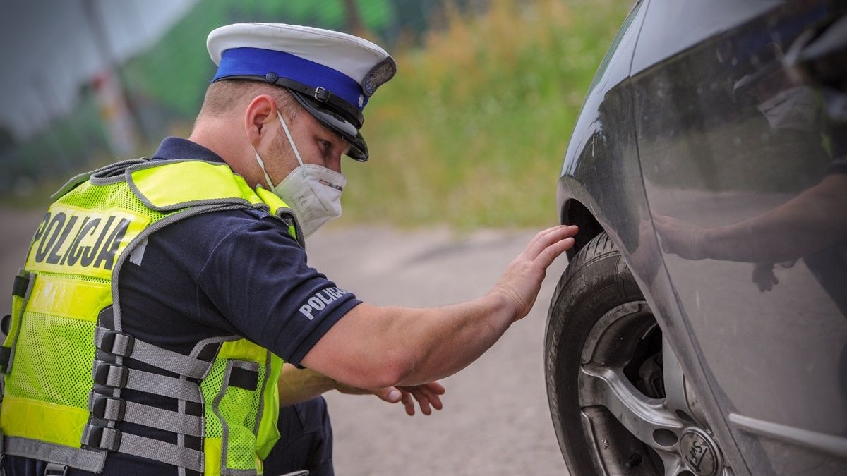 Policjant przygląda się oponie 