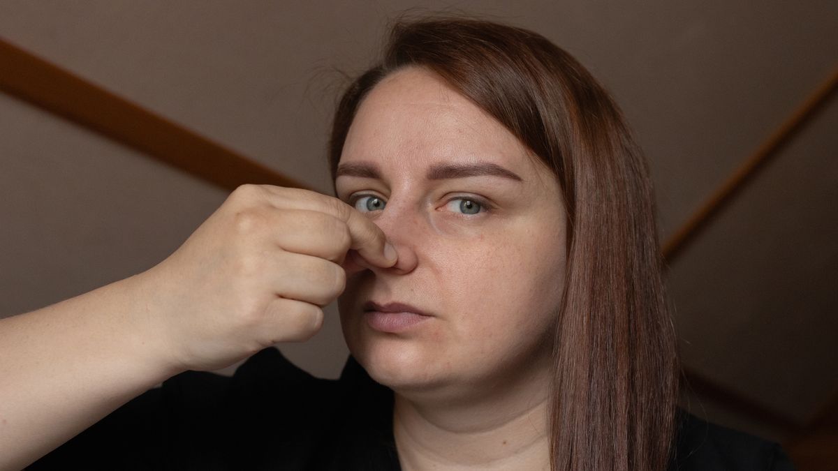 Woman Pinching Nose Indoors Expressing Discomfort or Reacting to Smell
A woman indoors with long hair, pinching her nose due to an unpleasant odor. Her serious facial expression emphasizes an act of reaction or distaste. The setting appears domestic or casual.
Iuliia Burmistrova