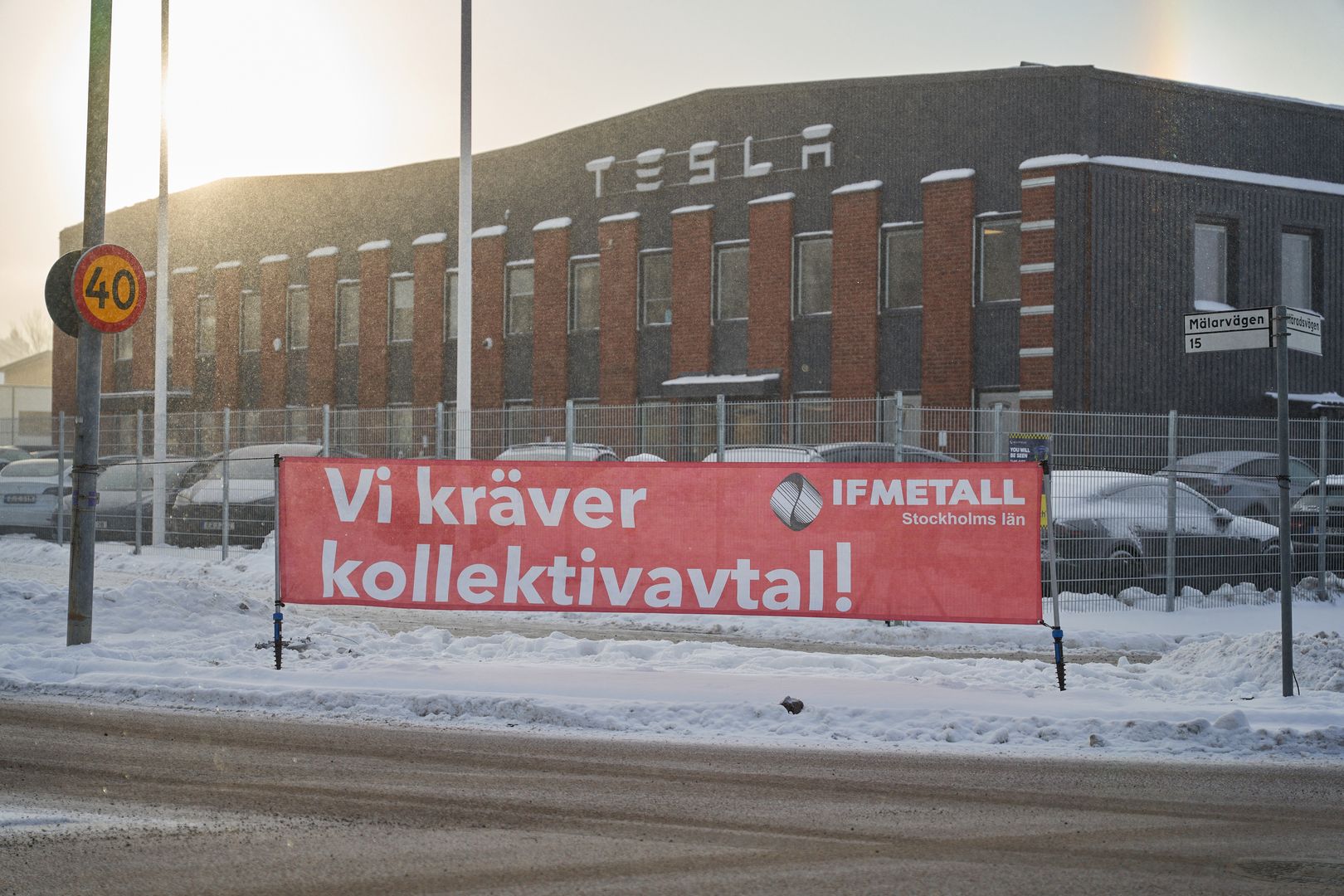 A banner from IF Metall union reading "We Demand a Collective Agreement" during a labor protest outside the Tesla Inc. service center in Segeltorp, Sweden, on Tuesday, Dec. 5, 2023. Tesla's deliveries to Sweden are at risk of being blocked from across the Nordic region after unions asked their neIFhboring peers to bolster their weeks-long strike. Photographer: Erik Flyg/Bloomberg via Getty Images