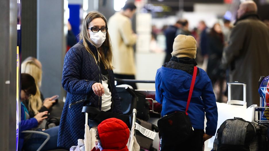 KRAKOW, POLAND - FEBRUARY 26: A woman wears a face mask at the Krakow Airport in Poland on February 26, 2020. Polish government has taken preventing measure at the airports due to the coronavirus outbreak in Italy and now spreading around Europe. (Photo by Stringer/Anadolu Agency via Getty Images)