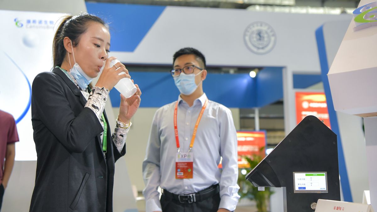 HAIKOU, CHINA - NOVEMBER 12: A visitor tries out vaccination by inhalation using atomized water instead of CanSinoBIO's inhaled COVID-19 vaccine at the booth of CanSino Biologics Inc. (CanSinoBIO) during the 5th Hainan International Health Industry Expo at Hainan International Convention and Exhibition Center on November 12, 2021 in Haikou, Hainan Province of China. (Photo by Luo Yunfei/China News Service via Getty Images)