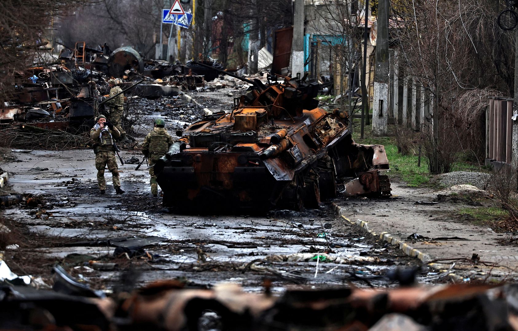 A soldier takes a photograph of his comrade as he poses beside a destroyed Russian tank and armoured vehicles, amid Russia's invasion on Ukraine, in Bucha, in Kyiv regionA soldier takes a photograph of his comrade as he poses beside a destroyed Russian tank and armoured vehicles, amid Russia's invasion on Ukraine, in Bucha, in Kyiv region, Ukraine April 2, 2022.,Image: 676103762, License: Rights-managed, Restrictions: , Model Release: no, Credit line: ZOHRA BENSEMRA / Reuters / ForumZOHRA BENSEMRA / Reuters / Forumdiplomacy, civil unrest, war, category_code_europ, category_code_war, category_code_dip, category_code_vio, category_code_diplomacy, category_code_civil unrest