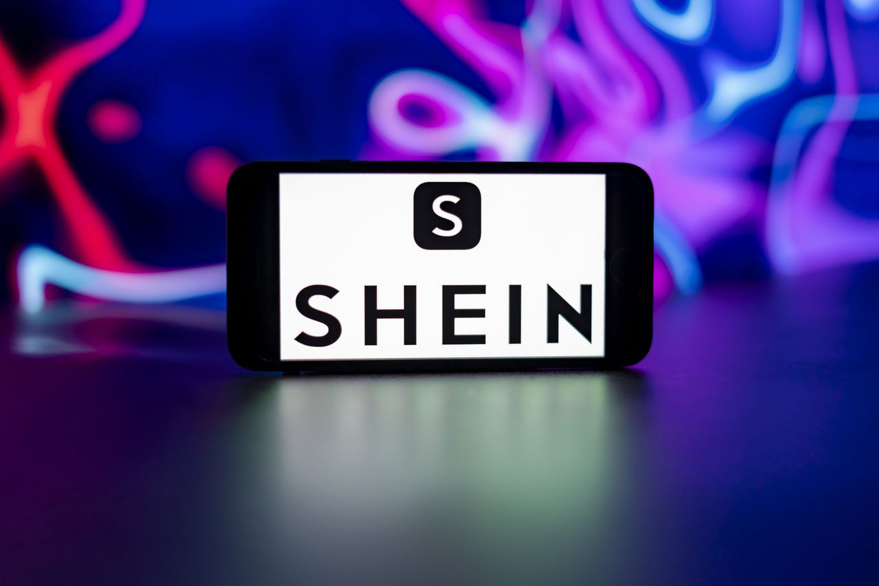 GERMANY - 2024/08/16: In this photo illustration, a smartphone with the website of fashion e-commerce company Shein is seen in front of business logo. (Photo Illustration by Timon Schneider/SOPA Images/LightRocket via Getty Images)