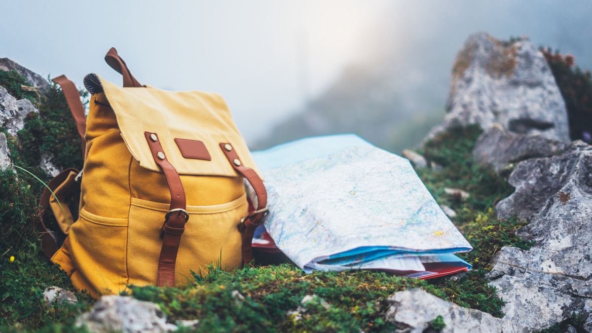Hipster hiker tourist yellow backpack and map europe on background green grass nature in mountain, blurred panoramic landscape, traveler relax holiday concept, view planning wayroad in trip vacationbackpack, map, tourist, traveler, trip, lifestyle, yellow, bag, route, holiday, hipster, planning, mock, mockup, up, background, blank, blurred, summer, backdrop, flare, hiking, nature, adventure, view, sightseeing, attractive, trekking, sunset, travel, freedom, landscape, foggy, sunlight, horizon, hiker, tourism, sunrise, vacation, relax, concept, way, road, navigation, europe, view, backpacker, roadtrip