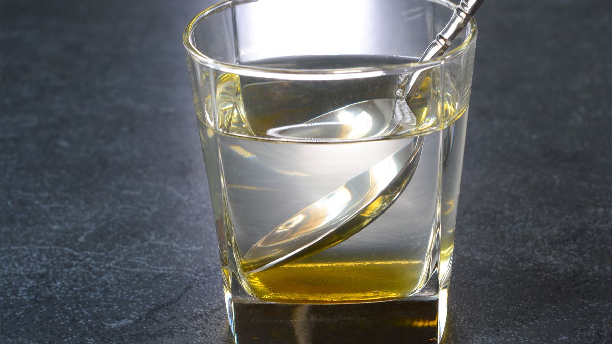 Honey WaterMixing warm water and honey to prepare honey water in a glass cupjayk7