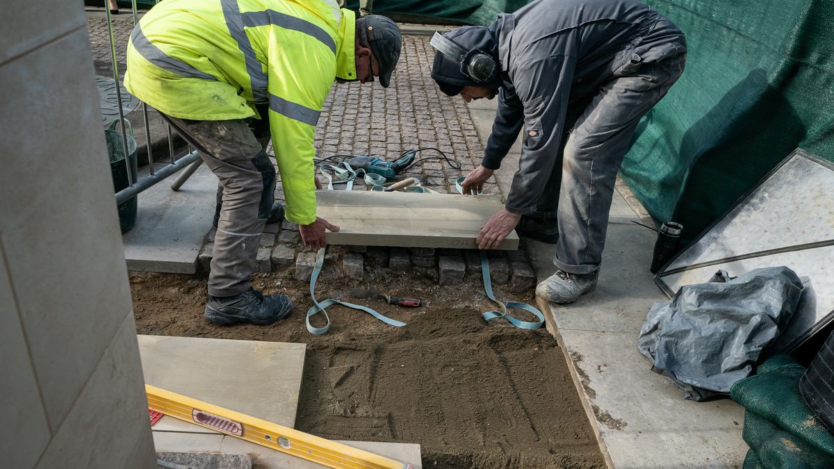 Workers from specialist heritage builders Daedalus Conservation puts the final touches to building works outside the Great West Door of Westminster Abbey, in London, completing the first significant change in twenty-five years, allowing step-free access. Picture date: Thursday February 2, 2023. (Photo by Aaron Chown/PA Images via Getty Images)