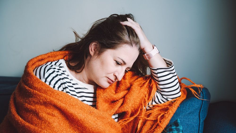 Loneliness, exhaustion, crisis. Mature woman sit on couch at home wrapped in plaid
Sad woman at home alone. Woman wrapped in orange warm plaid feels sad. Early menopause, hormone therapy
Olga Rolenko