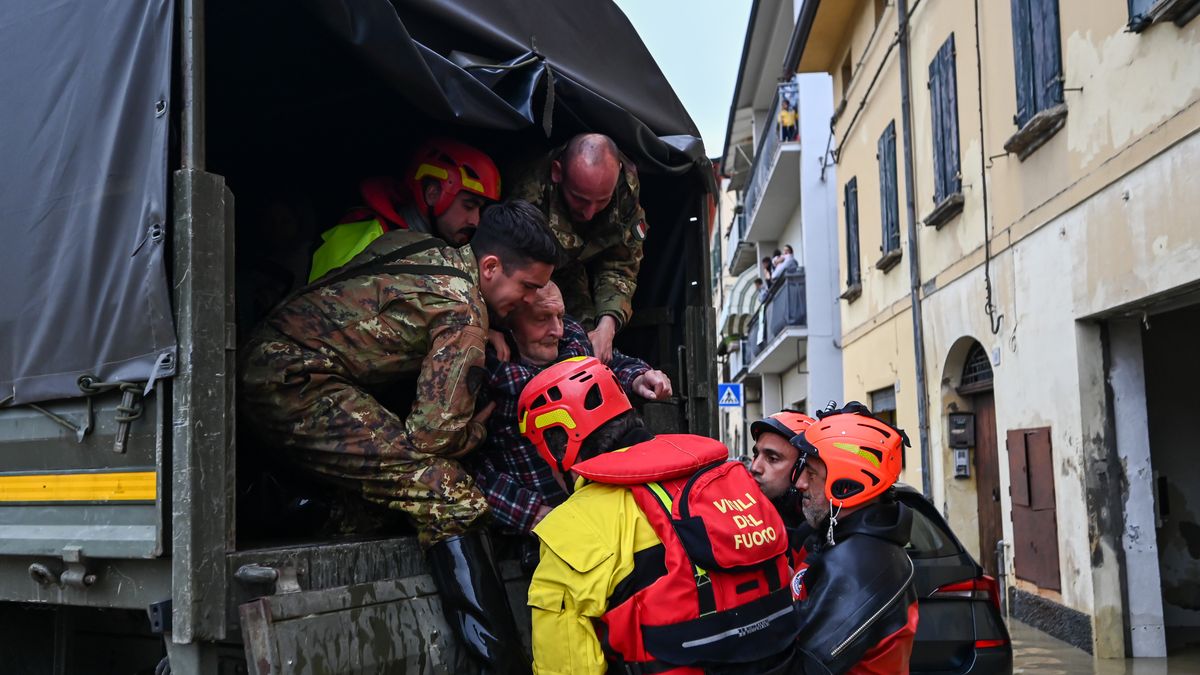 CASTEL BOLOGNESE, ITALY - MAY 17: Firefighters and military personnel help a senior citizen to evacuate as flood hits Castel Bolognese, Emilia-Romagna, Italy on May 17, 2023. At least three people were killed and thousands of others displaced after torrential rains poured over the northern Italian region of Emilia Romagna, local authorities said on Wednesday. (Photo by Piero Cruciatti/Anadolu Agency via Getty Images)