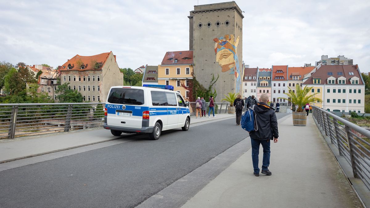 GOERLITZ, GERMANY - OCTOBER 03: View to people and a police vehicle on the Altstadtbruecke at the German-Polish border across the river Neisse to the Dreiradenmuehle in Zgorzelec, Poland, from Goerlitz, Germany, on October 3, 2024. (Photo by Frank Hoensch/Getty Images)