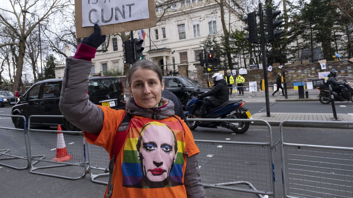 (EDITORS NOTE: Image contains profanity) Protester with a highly profane sign wearing a t-shirt lampooning Vladimir Putin as a character wearing make up on an LGBT rainbow flag outside the Russian embassy against the Russian invasion of Ukraine and the ongoing war on 28th February 2022 in London, United Kingdom. Protests all over the World have materialised as people wish to show their support for Ukrainians and their country. (photo by Mike Kemp/In Pictures via Getty Images)