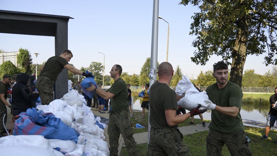 People and members of the territorial defense army fill bags with sand as they prepare for the flood wave to reach the southwestern city of Wroclaw, Poland, on September 18, 2024. The government outlines a reconstruction plan once the floodwaters subside, using both state funds and some of the 1.5 billion euros ($1.7 billion) made available by the European Union for impacted countries, Polish Prime Minister Donald Tusk says. (Photo by Aleksander Kalka/NurPhoto via Getty Images)