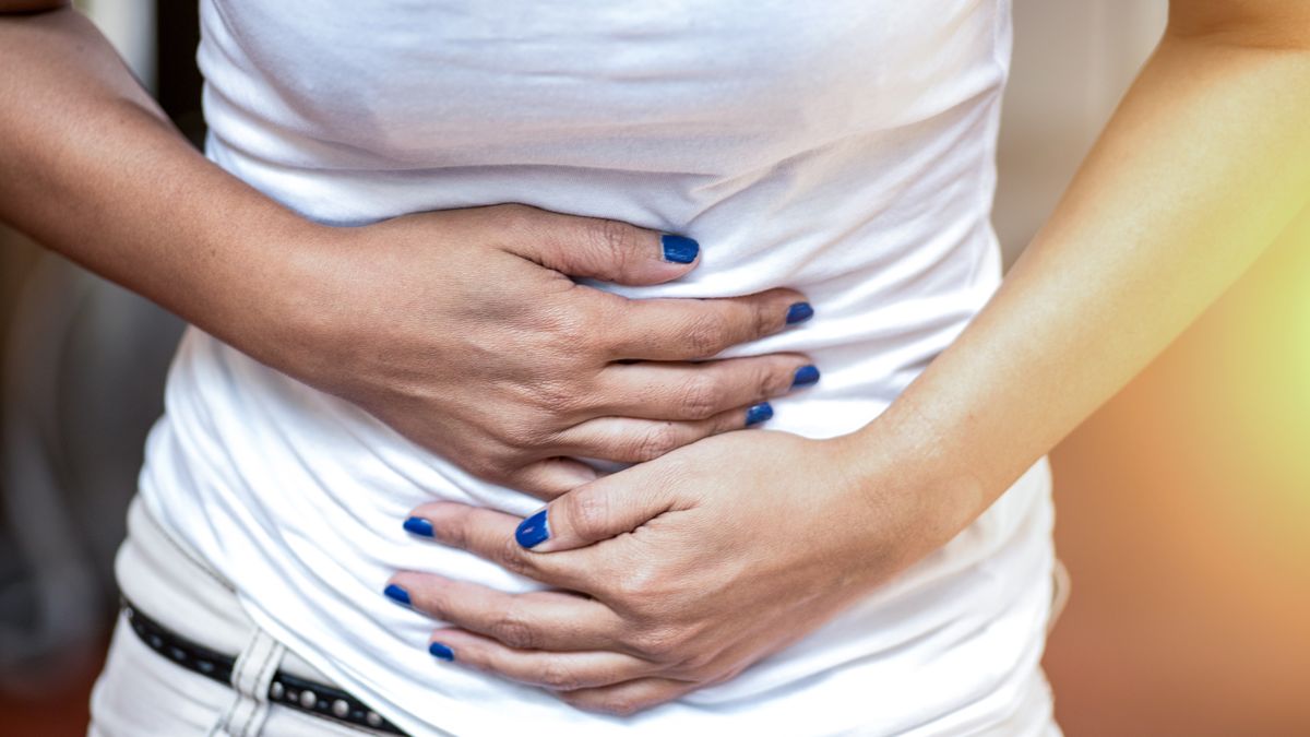 Young woman having abdominal pain, upset stomach or menstrual crampsYoung woman having abdominal pain, upset stomach or menstrual crampsboonchai wedmakawandconcepts & topics