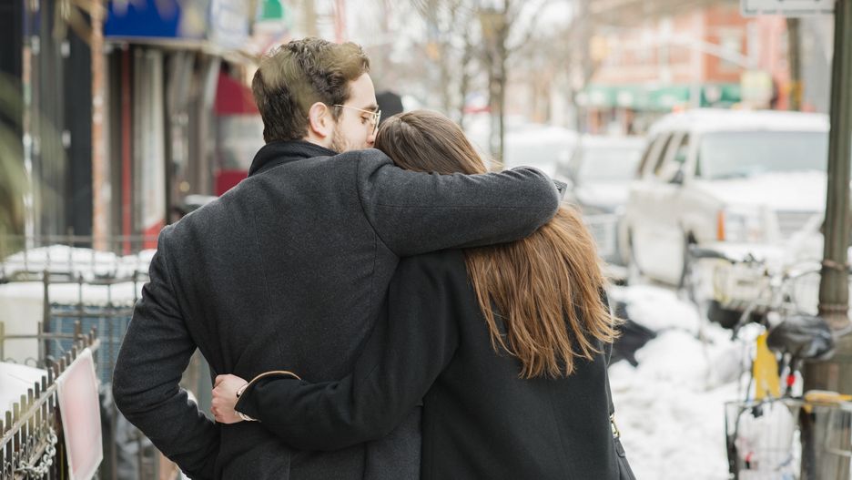 Rear view of young couple walking on city streetThe Good Brigade