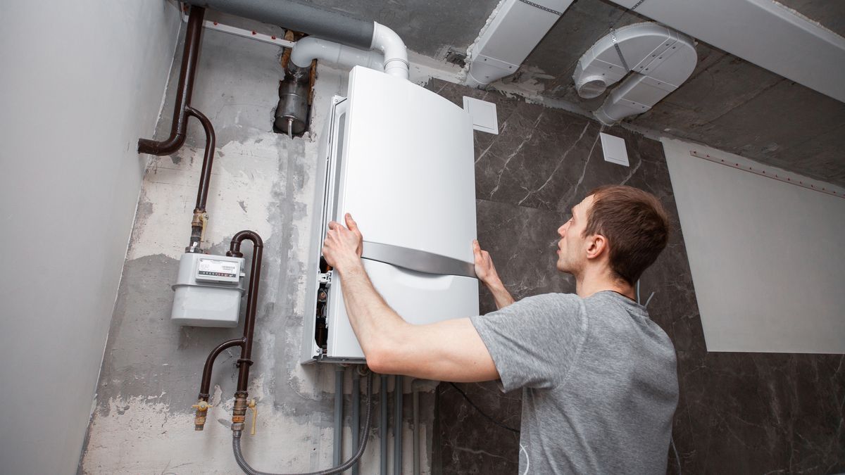 Installation and setting the new gas boiler for hot water and heating. Technician servicing the house heating system.gas, boiler, engineer, pipes, repair, water meter, new, renovation, plumber, plumbing, work, worker, construct, constructure, valve, install, installation, bright, modern, control, service, white, faucet, water, wall, diy, crash, overlap, industrial, temperature, hot, cold, pressure, house, concrete, pvc pipe, close up, system, heating, corrugated, man, tool, check, mechanic, handyman, energy, gas, boiler, engineer, pipes, repair, water meter, new, renovation, plumber, plumbing, work, worker, construct, constructure, valve, install, installation, bright, modern, control, service, white, faucet, water, wall, diy, crash, overlap, industrial, temperature, hot, cold, pressure, house, concrete, pvc pipe, close up, system, heating, corrugated, man, tool, check, mechanic, handyman, energy