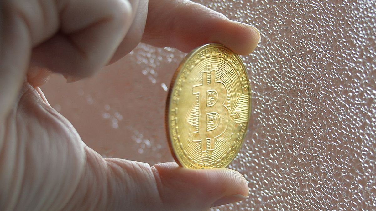 In this photo illustration a nitizen holds a physical commemorative Bitcoin.On Tuesday, January 5, 2020, in Dublin, Ireland. (Photo by Artur Widak/NurPhoto via Getty Images)