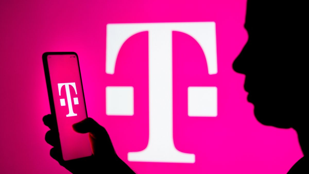 BRAZIL - 2022/03/22: In this photo illustration, a woman's silhouette holds a smartphone with the T-Mobile US (Deutsche Telekom) logo in the background. (Photo Illustration by Rafael Henrique/SOPA Images/LightRocket via Getty Images)