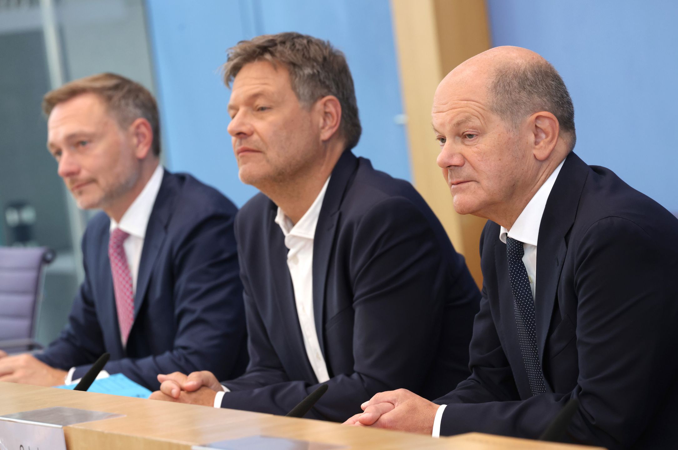 BERLIN, GERMANY - JULY 05: German Chancellor Olaf Scholz (R), Finance Minister Christian Lindner (L) and Economy and Climate Action Minister Robert Habeck speak to the media to present the coalition government's plan for the 2025 federal budget on July 05, 2024 in Berlin, Germany. Negotiations went deep into the night yesterday and today and concluded months of wrangling that many feared could have lead to the breakup of the three-party coalition government. (Photo by Sean Gallup/Getty Images)