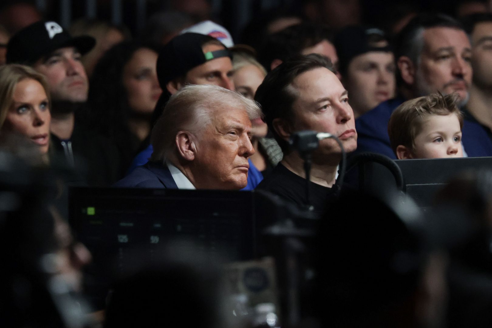 MIAMI, FLORIDA - APRIL 12: U.S. President Donald Trump watch the Ultimate Fighting Championship with Elon Musk at the Kaseya Center on April 12, 2025 in Miami, Florida. The Trump administration issued a rule late Friday that spared smartphones, computers, semiconductors, and other electronics from some of the tariffs they have enacted. (Photo by Joe Raedle/Getty Images)