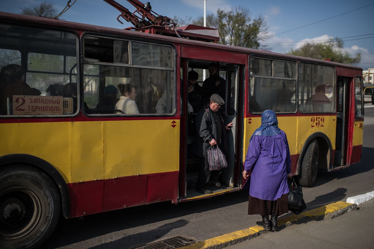 TIRASPOL, MOLDOVA - APRIL 07: An elderly man exits a trolleybus on April 7, 2014 in Tiraspol, Moldova. (Photo by Oleksii Furman/Getty Images)