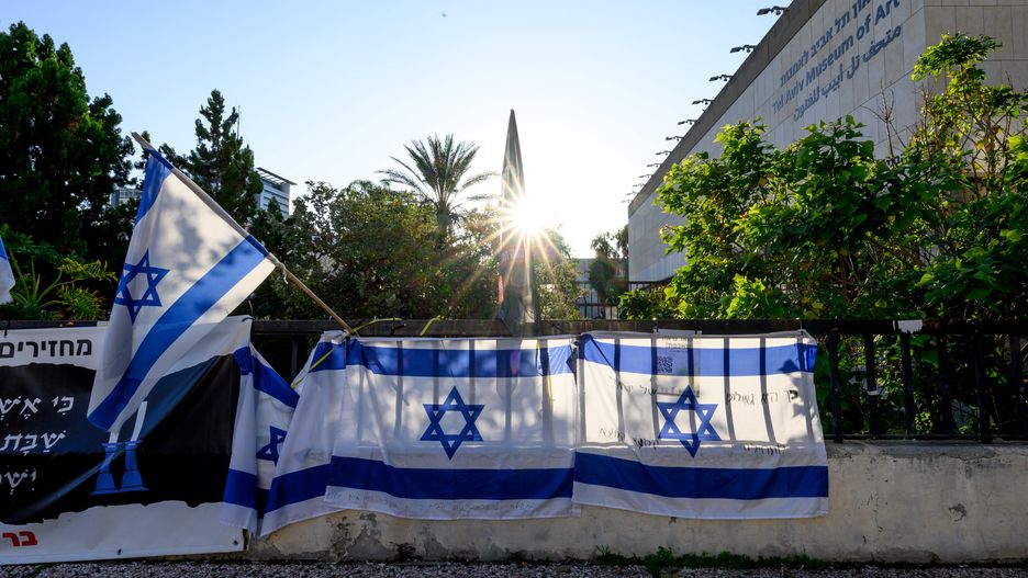 TEL AVIV, ISRAEL - FEBRUARY 21: Israeli flags hang at "Hostages Square" outside the HaKirya base, which serves as Israel Defense Forces (IDF) headquarters, on February 21, 2024 in Tel Aviv, Israel. Hamas members on October 7 attacked Israeli towns around the Gaza Strip, killing more than 1200 people, including women and children, and kidnapping more than 200 others. About 130 hostages remain in captivity, according to published reports. (Photo by Roy Rochlin/Getty Images)