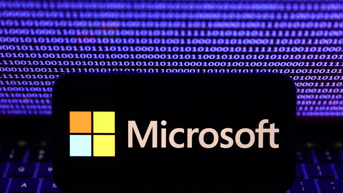 A binardy code displayed on a laptop screen and Microsoft logo displayed on a phone screen are seen in this illustration photo taken in Krakow, Poland on October 30, 2023. (Photo by Jakub Porzycki/NurPhoto via Getty Images)