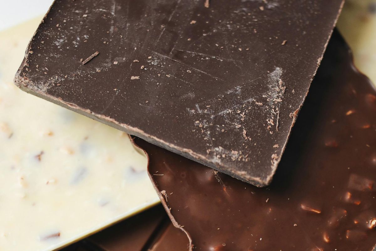 Chocolate can go bad, but white film on it doesn't prove that.